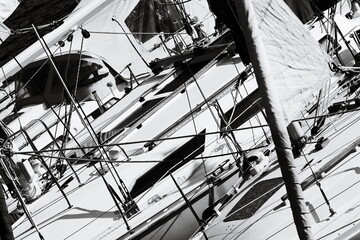 A monochrome image of a sailboat floating on the water, great for use in editorial or commercial...