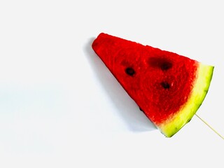 a slice of fresh watermelon on a stick