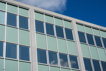 Mid century modern office windows with a blue sky.