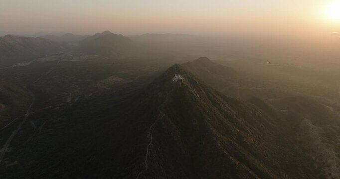 Aerial view of temple on mountain at sunset, India.