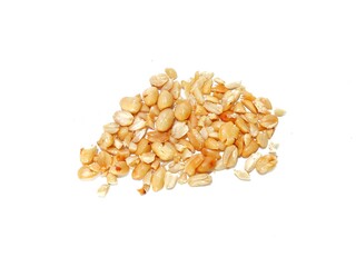 Fresh crumbled peanuts isolated on white background. Roasted peanuts, fried peanuts. Whole groundnut pieces. Peanut fractions top view on white background.