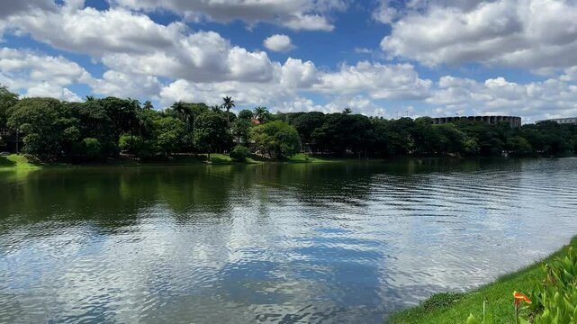 Sunny Day at Pampulha Lagoon in Belo Horizonte, Brazil, Featuring Colorful Flowers, Iconic Mineir&atilde;o Stadium and Mineirinho Arena Across the Water