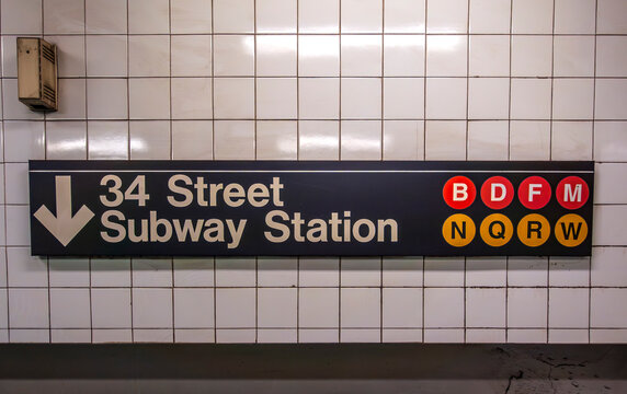 New York, NY - US - Jul 6 2025 This sign marks the 34 Street Subway Station, a major NYC hub serving the B, D, F, M, N, Q, R, and W lines, guiding riders through the city's vast transit web.