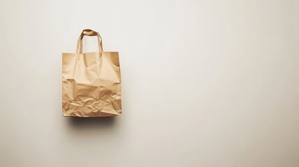 Brown paper shopping bag against a light background.