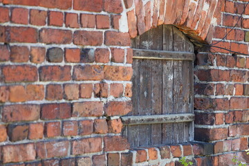 A simple brick building with a single window on the facade, suitable for various architectural and urban planning contexts
