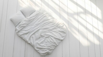 White bedding set on a light wood floor.