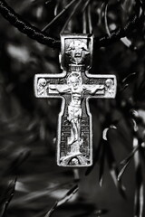 A silver cross with a picture of Jesus Christ, perfect for Christian-themed designs and visuals