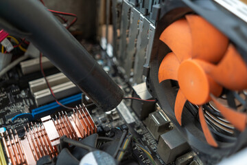 Vacuuming inside the computer system unit.