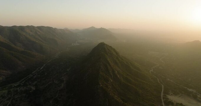 Aerial view of sunset over mountains and valleys, India.