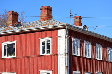 A red building with a clock tower, perfect for cityscape or architecture use