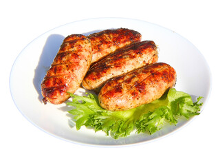 Grilled meat sausages and green salad leaves on a plate