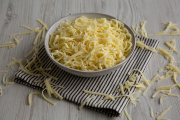 Organic Shredded Mozzarella Cheese in a Bowl, side view.