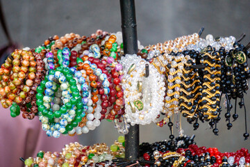 Various types and models of beaded bracelets are arranged on display.