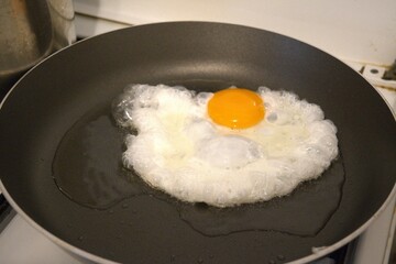 One fried egg in the pan close up