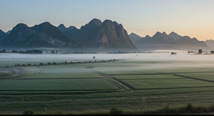 Green Fields and Mountains in a Misty Valley - Peaceful Morning Scene