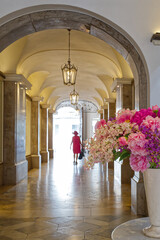 Shopping arcade with beautiful flowers and a lady in pink