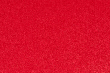 Bright red textured surface with smooth finish creating vibrant backdrop for design