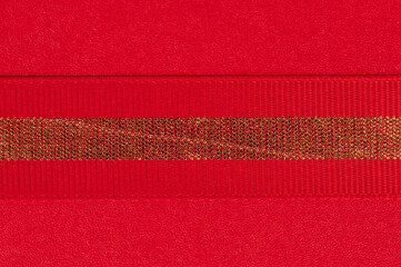 Bright red texture with shiny gold ribbon detail for crafts or decorations