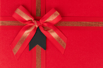 Bright red gift box adorned with shiny bow for special occasions and celebrations