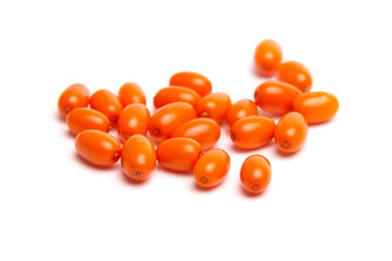 A group of bright orange sea buckthorn berries with a smooth, glossy texture, scattered on a white...