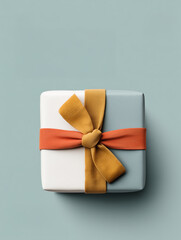 A single gift box with a white and blue base and a striking orange and yellow ribbon. The image is a clean, top-down view on a light blue background, emphasizing the colors and the act of gifting