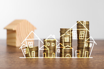 Increase in real estate value. Stacked coins and illustration of house on table