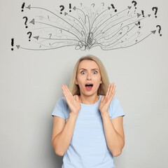Shocked woman on light grey background. Confused thoughts as doodles above her head. Stress,...
