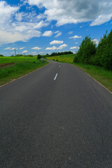 Fototapeta premium Highway wide road, transport and blue sky with clouds on a summer day