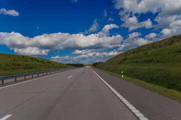 Highway wide road, transport and blue sky with clouds on a summer day
