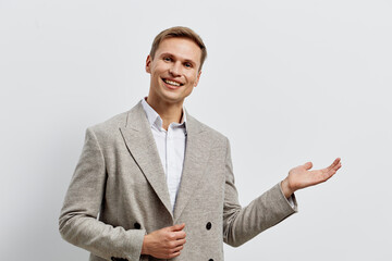 Smiling man wearing plaid blazer show gesture hold invisible object isolated white background...