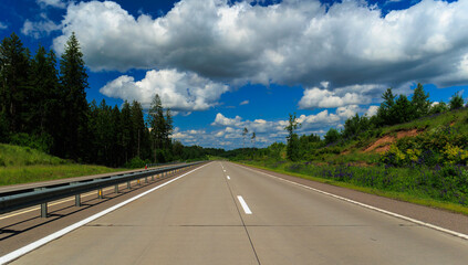 Highway wide road, transport and blue sky with clouds on a summer day