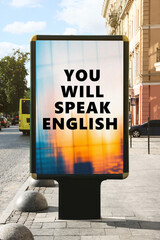 You Will Speak English text on advertising board in city. Language course