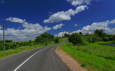Road view on a summer day. Highways, roadside and white road line markings.