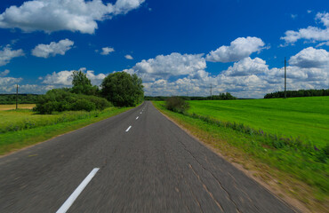 The effect of speed on the road and blurred. View of the road on a summer day.