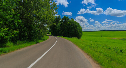 Naklejka premium Road view on a summer day. Highways and roadside, white road line markings.
