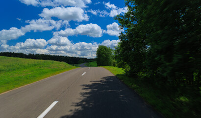 Road view on a summer day. Highways and roadside, white road line markings.