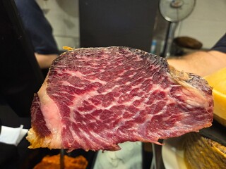 Delicious cured cecina sliced close-up for culinary use and gourmet presentation. Cecina - the famous Spanish salted and dried meat. Made from Angus beef. A cut of Angus beef