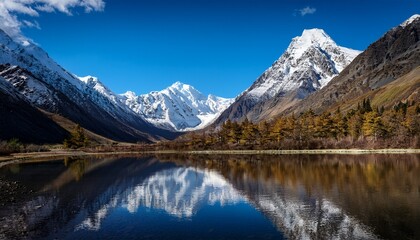 Fototapeta premium majestic snow capped mountains bathed in the golden light of the rising sun creating a breathtaking vista under a clear