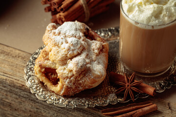 Vienna strudel and caffe latte on a silver tray.