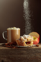 Vienna strudel and caffe latte on an old wooden table.