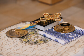 Orthodox Christian Religious Ceremony: Gold Cross, Chalice, and Prayer Book on Embroidered Cloth in...