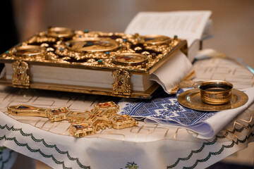 Orthodox Religious Ceremony Setup: Golden Gospel Book, Cross, Chalice, Cloth, and Prayer Book, Detailed Still Life, Traditional Decor