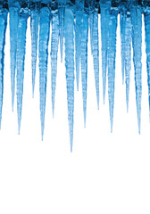 Fototapeta premium Numerous elongated blue icicles, highly translucent with visible crystalline structures, varying lengths and thicknesses, hanging against a transparent studio background with ample copy space,