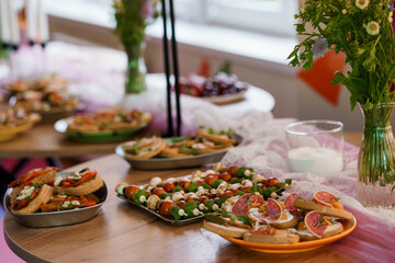 Lavish Party Buffet Table with Crostini, Skewers, and Flowers. Pink and Orange Decor, Elegant...