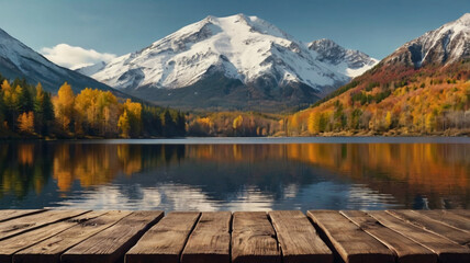 A serene lake reflects the majestic snowcapped mountains and vibrant autumn foliage, creating a picturesque landscape from a wooden dock