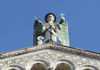 Statue of Archangel Michael with wings, sword, and cross atop the Church of San Michele in Foro,...