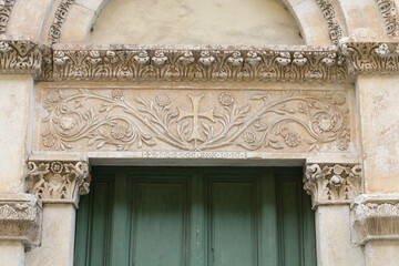 Marble lintel with carved floral cross and vegetal scrolls, portal of Santa Maria della Rosa,...