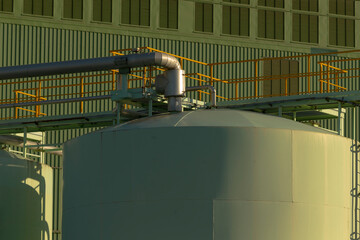 In a spacious industrial factory, there exists a sizable storage tank complete with a prominent...