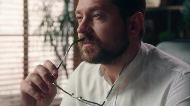 Pensive puzzled Caucasian employee taking off glasses man male entrepreneur pondering in office leader worker job problem business question businessman contemplating corporate boss think about answer