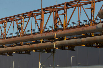 A bridge that has a significant number of pipes running over it, showcasing an intersection of...